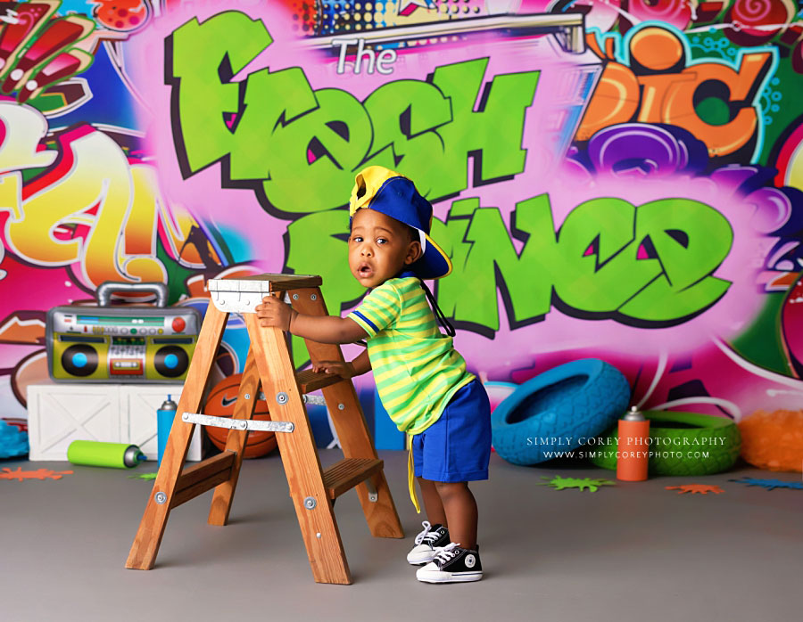 baby photographer near Douglasville, boy with ladder during fresh prince studio session