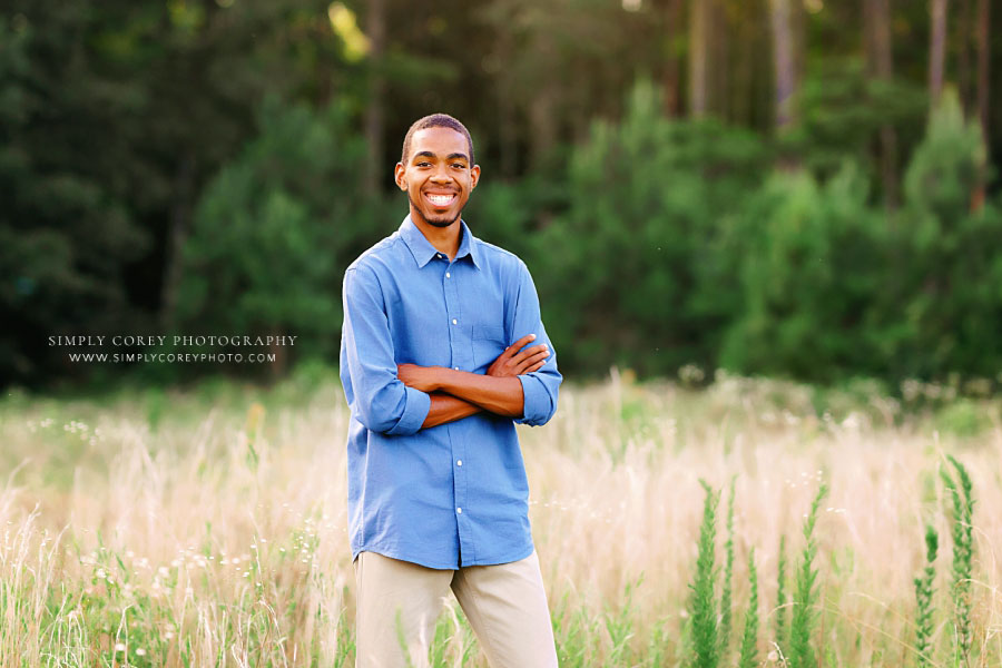 Newnan senior portrait photographer, teen boy smiling outside in field