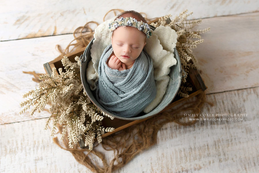 newborn photographer near Dallas, GA; baby girl in blue wrap with flower crown