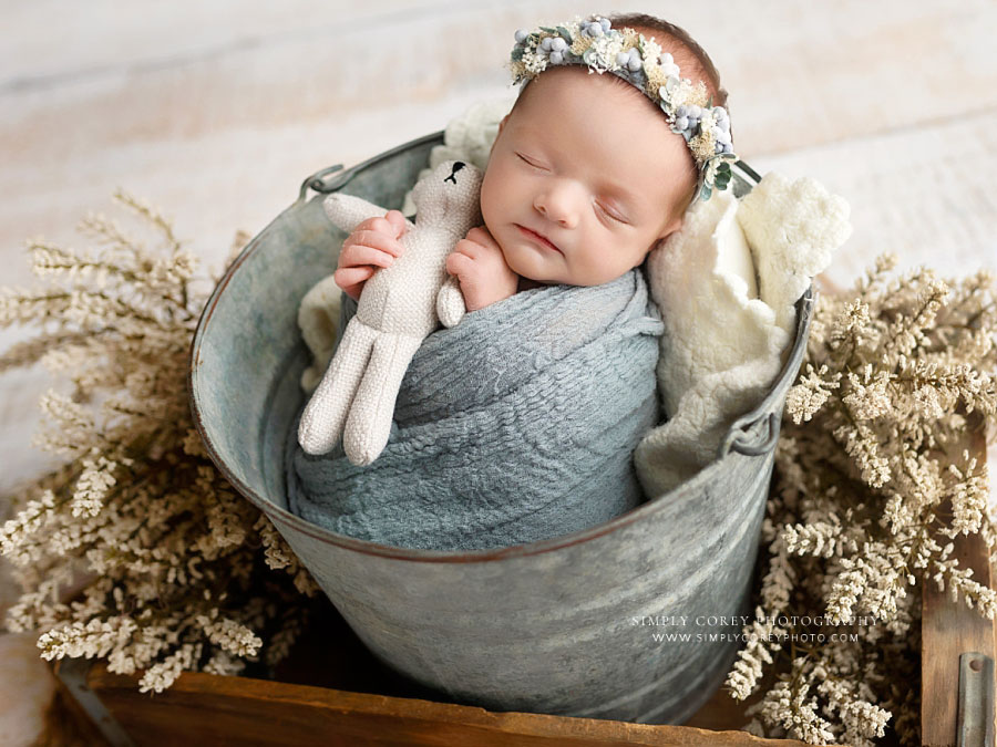 Atlanta newborn photographer, baby girl in bucket with blue wrap and flower crown