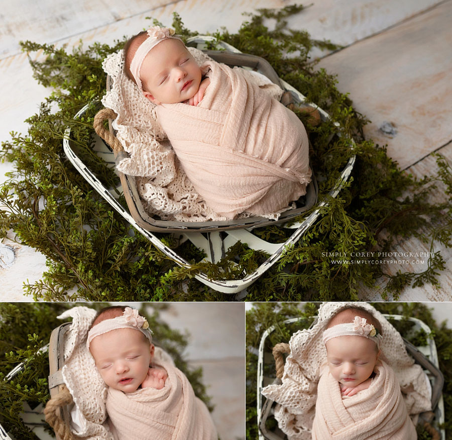 Bremen newborn photographer, baby girl in pink wrap with baskets and greenery