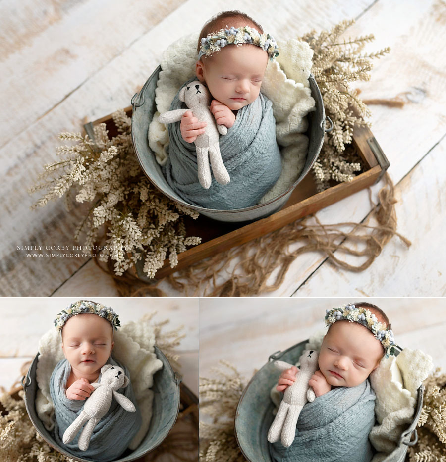 newborn photographer near Carrollton, GA; baby girl in light studio set with flowers