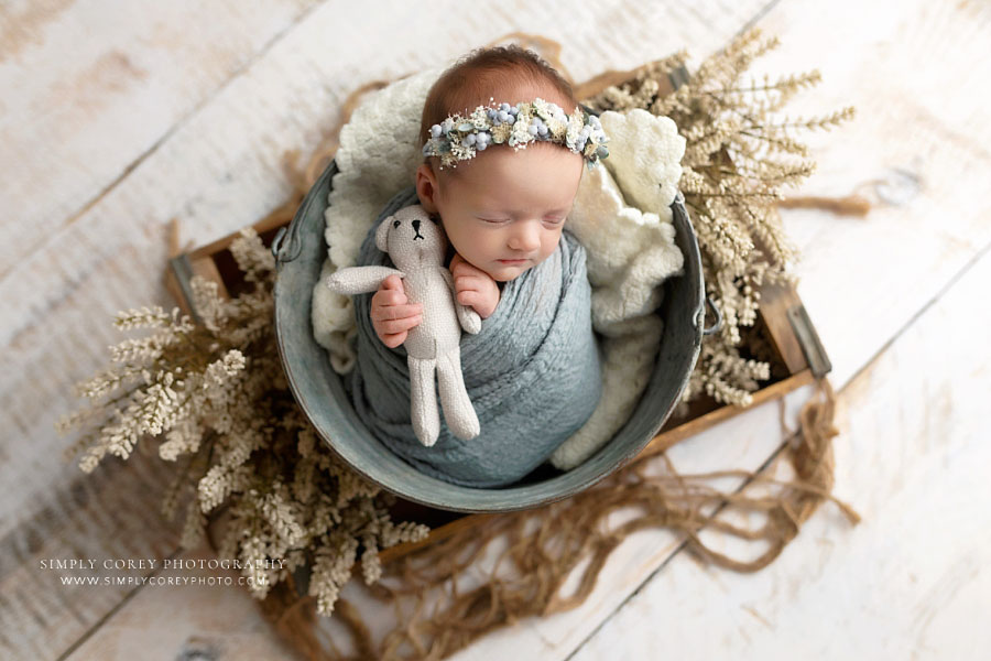 newborn photographer near Douglasville baby girl in blue with flowers and teddy bear