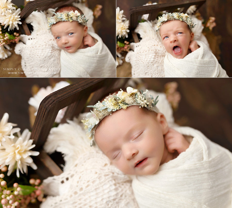 newborn photographer west Georgia, baby girl making funny faces on little bed with flower crown