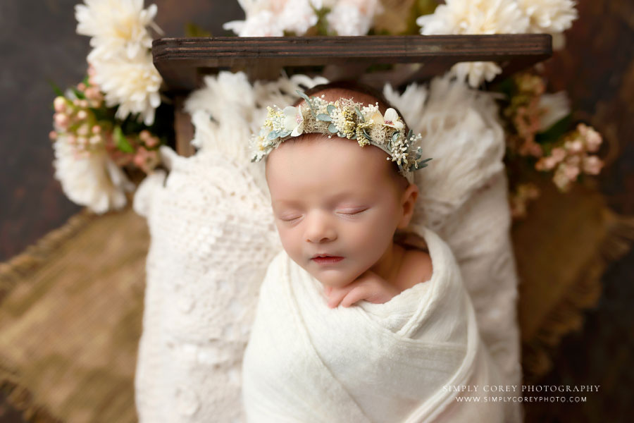 Villa Rica newborn photographer, baby girl sleeping in little bed with flower crown and florals