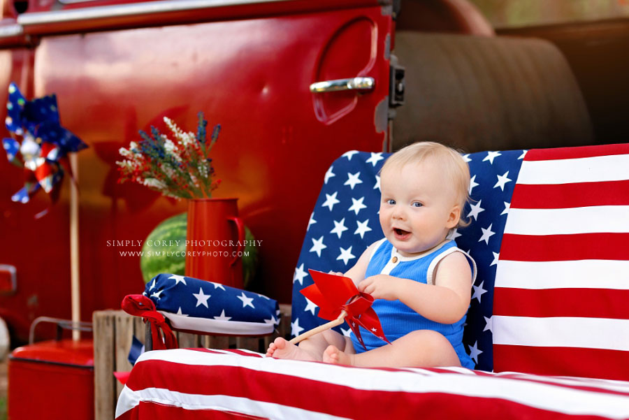 mini session photographer near Carrollton, GA; baby outside with VW bus for 4th of July