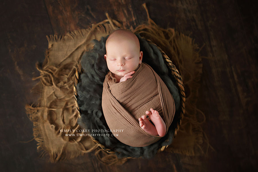 Dallas newborn photographer in GA; baby boy in basket with brown gray studio set