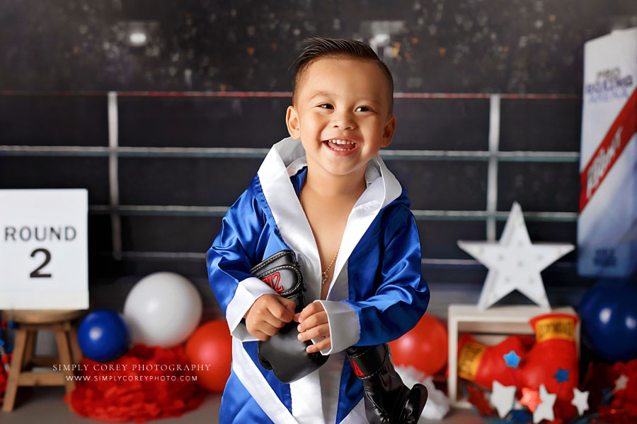 baby photographer near Atlanta, toddler in blue boxing robe for studio milestone session