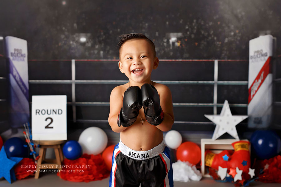 Douglasville baby photographer, toddler wearing boxing gloves for studio milestone session