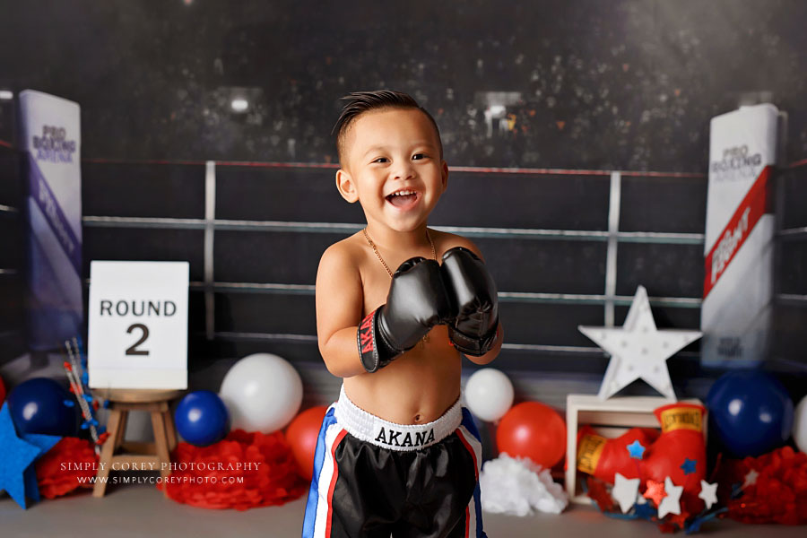 Villa Rica baby photographer, toddler in boxing gloves for studio milestone session