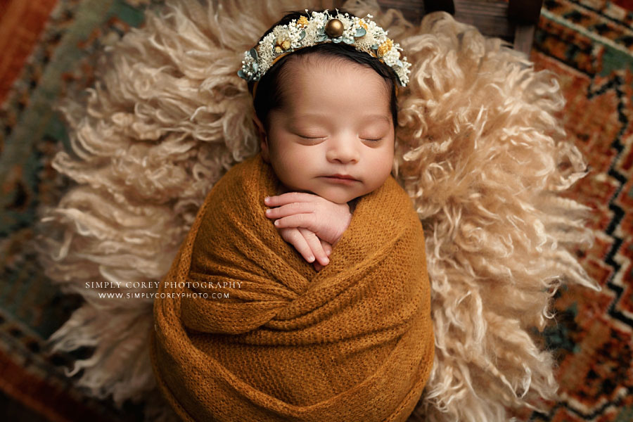 Hiram newborn photographer, baby girl in gold wrap and flower crown