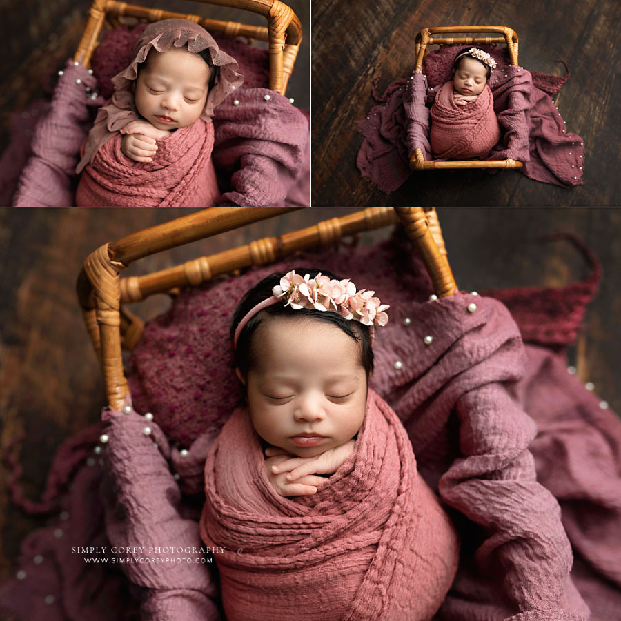newborn photographer near Villa Rica, baby girl with pink swaddle in rattan bed