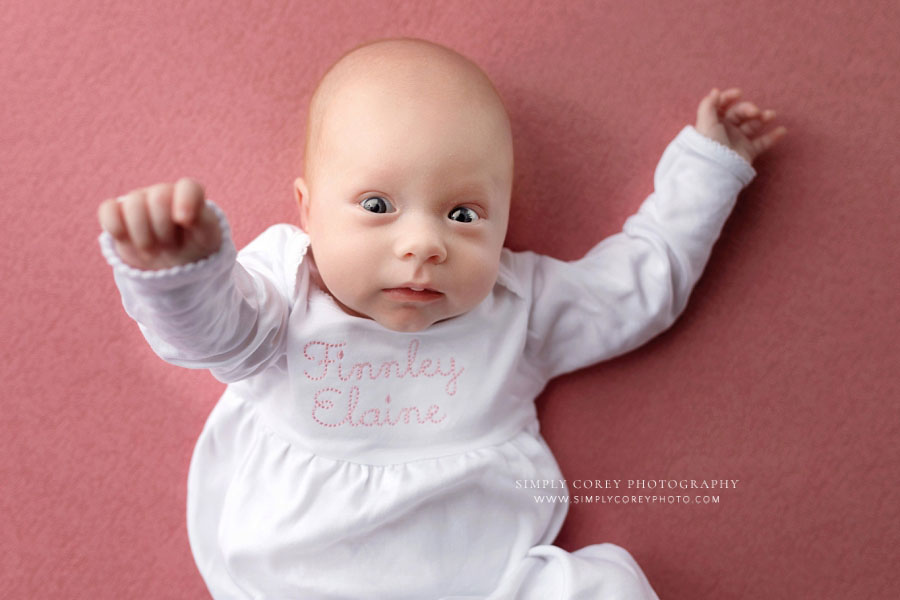 newborn photographer near Douglasville, awake baby girl in pink and white