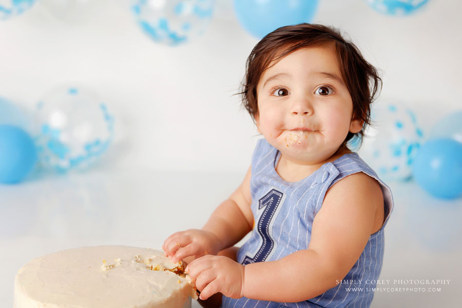 cake smash photographer near Powder Springs, baby boy with blue and white balloons in studio