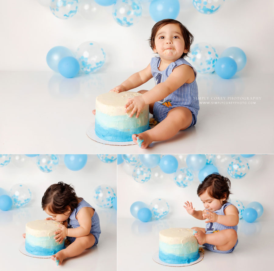 cake smash photographer near Villa Rica, baby putting face in ombre blue cake in studio