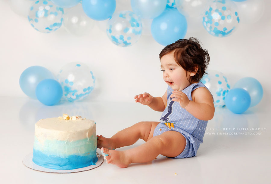 Mableton cake smash photographer, baby with toes in ombre-cake on studio set