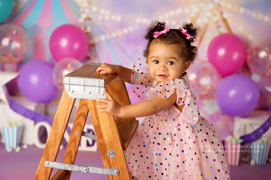 Newnan baby photographer, girl with ladder and balloons for circus milestone session