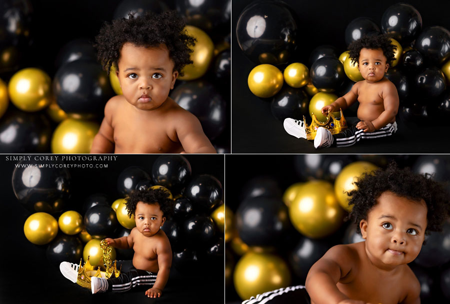 Fairburn baby photographer, boy with gold and black balloons for first birthday milestone session