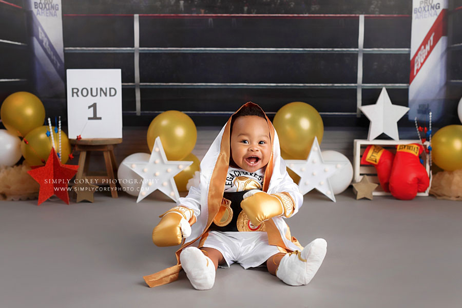 baby photographer near Powder Springs, boy in gold and white boxing set for milestone session