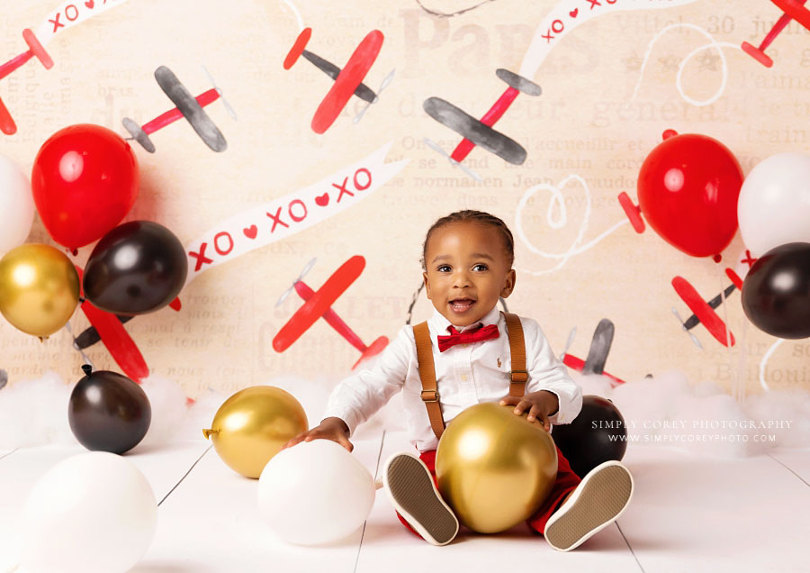 Fairburn baby photographer, boy with balloons with valentine milestone session