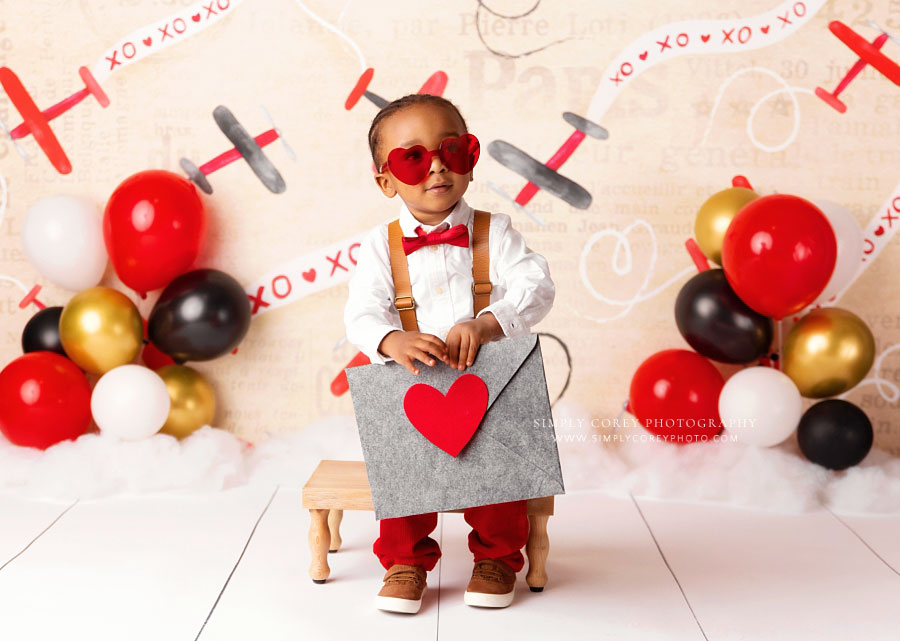Newnan baby photographer, boy holding valentine for two year milestone session