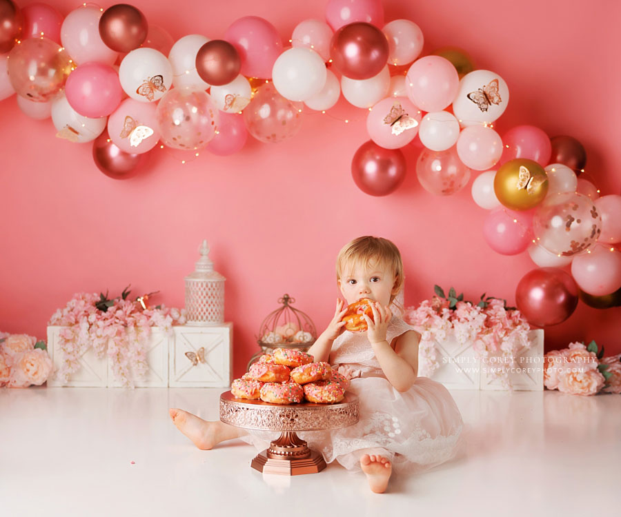 Atlanta cake smash photographer, pink butterfly balloon garland with donuts