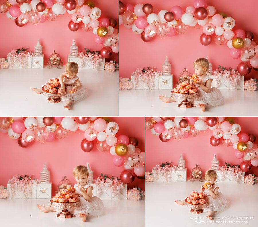 cake smash photographer near Douglasville, baby on pink butterfly set with balloons and donuts