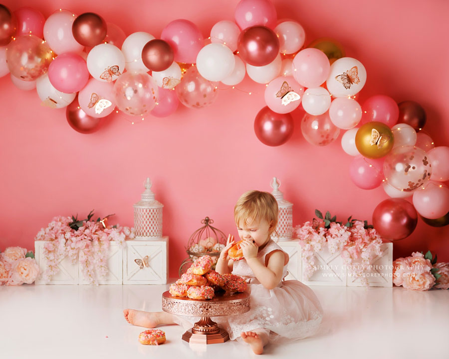 cake smash photographer near Villa Rica, pink butterfly set with sprinkle donuts