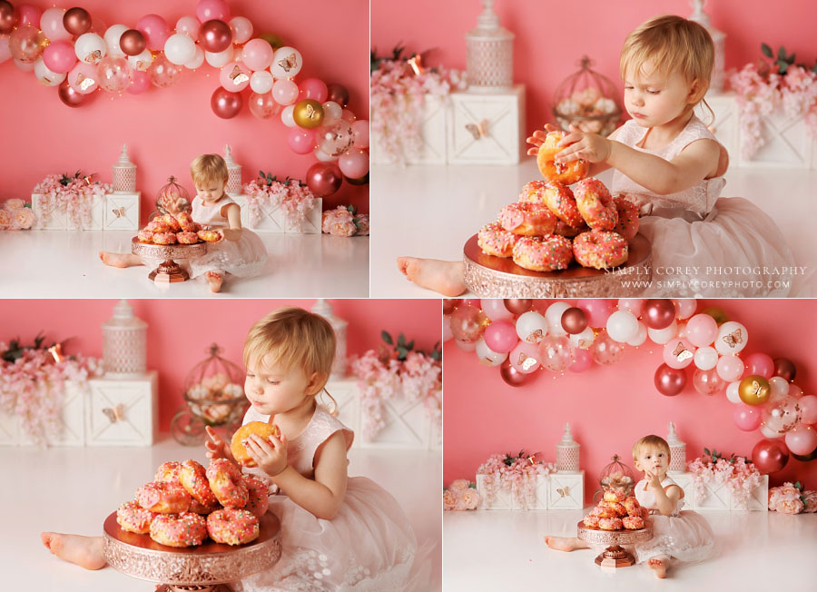 Carrollton cake smash photographer in GA, baby eating donuts with pink balloon set