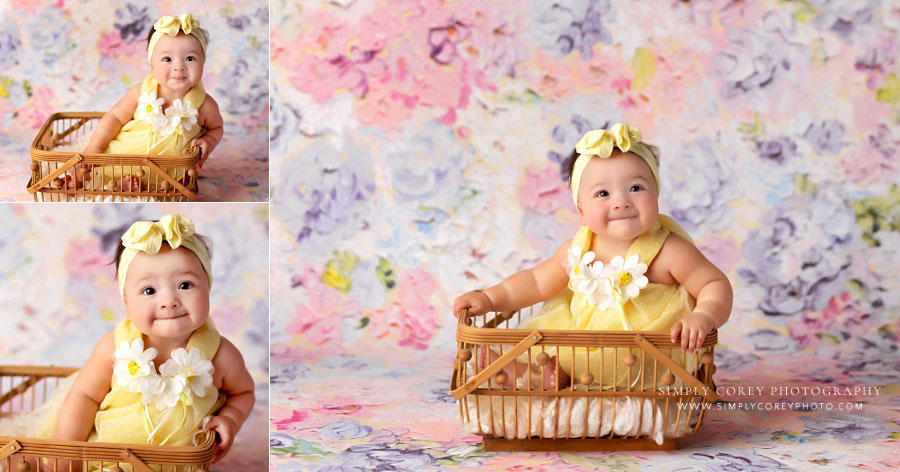baby photographer near Dallas, GA; six month old in basket with floral backdrop in studio