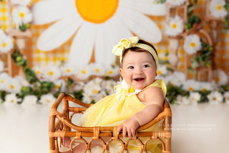 baby photographer near Newnan, studio milestone session on yellow set with daisies