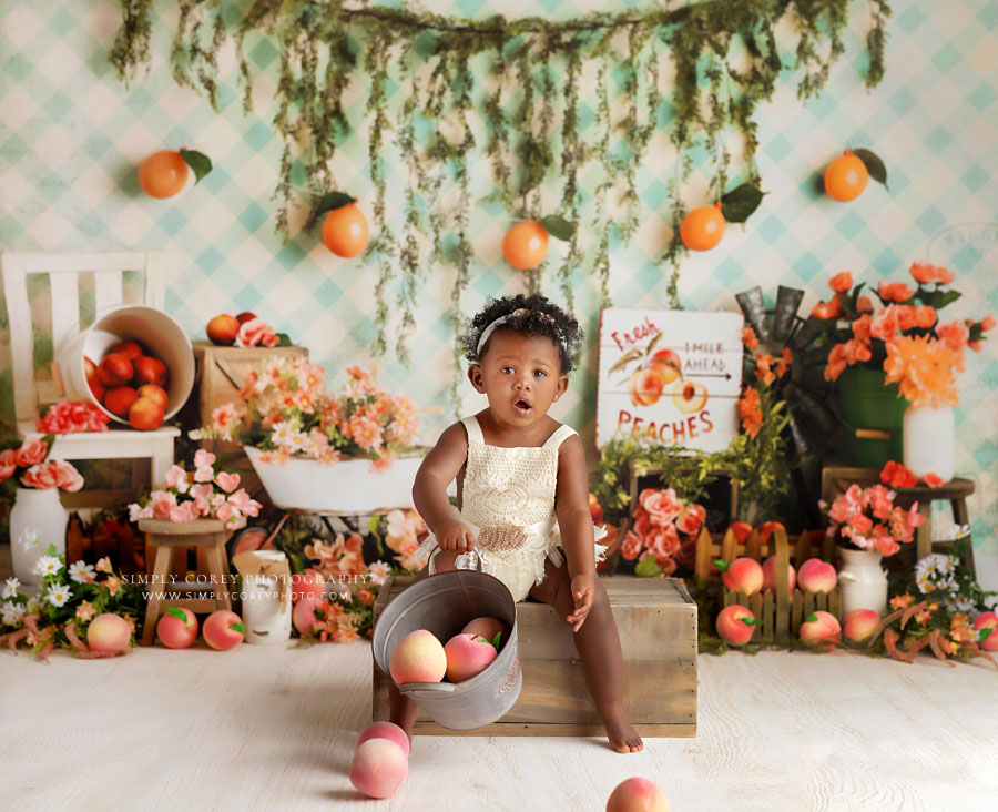 Newnan baby photographer, girl with bucket of peaches for one year milestone session