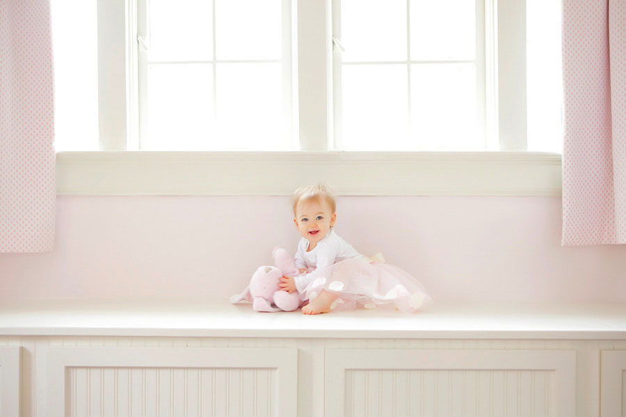 Atlanta baby photographer, girl sitting in window seat at home