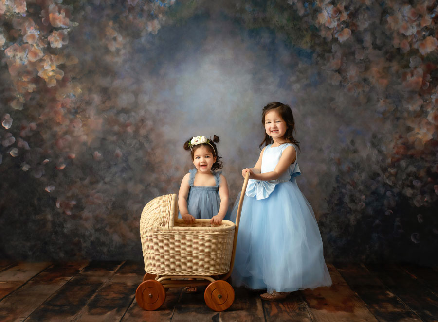 Atlanta kids photographer, sisters in studio with a baby carriage