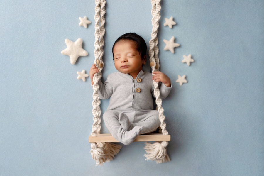 Atlanta newborn photographer, baby boy on swing with stars
