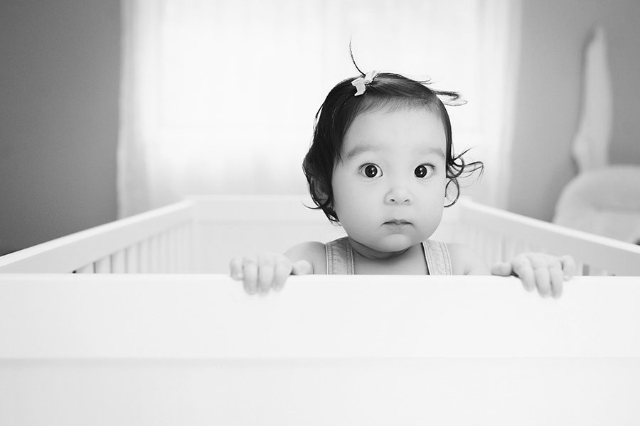 baby photographer near Atlanta, girl in crib at home in black and white