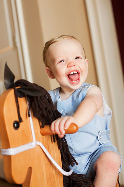 baby photographer near Newnan, boy riding rocking horse at home