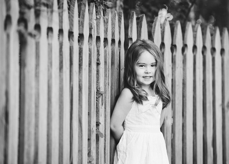 Bremen children's photographer in Georgia, girl outside by wooden fence