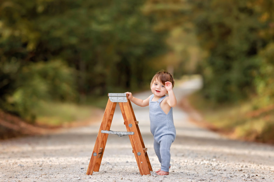 Carrollton baby photographer in Georgia, boy on country road with ladder