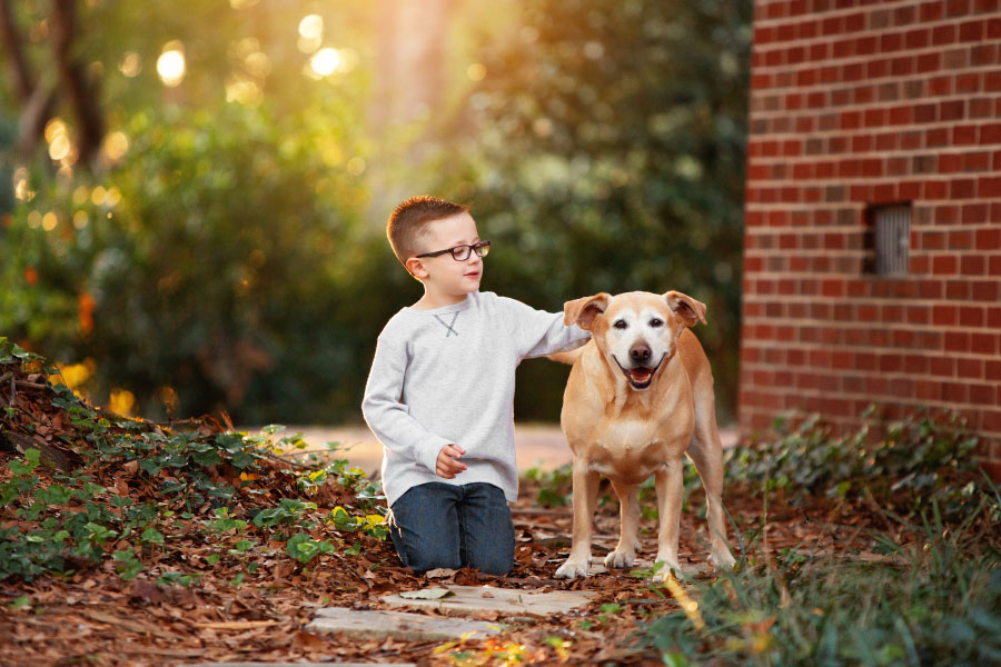Carrollton children's photographer, boy with dog outside at home