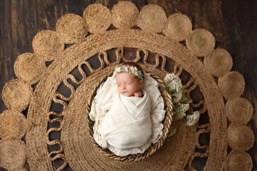 Carrollton newborn photographer in GA, baby girl on jute rug