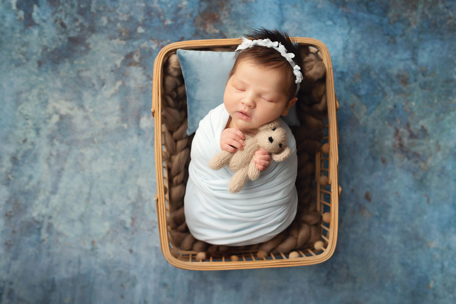 Dallas, GA newborn photographer, baby girl in blue and brown with bear