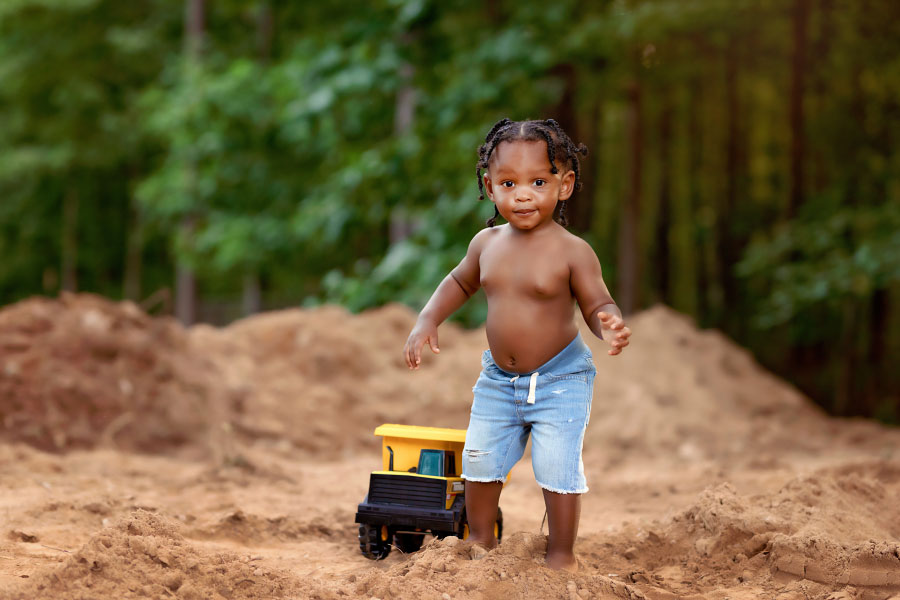Douglasville baby photographer, boy outside in dirt with Tonka truck