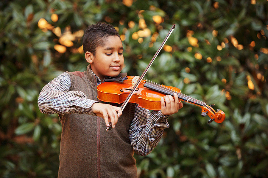 Douglasville children's photographer, boy playing viola outside