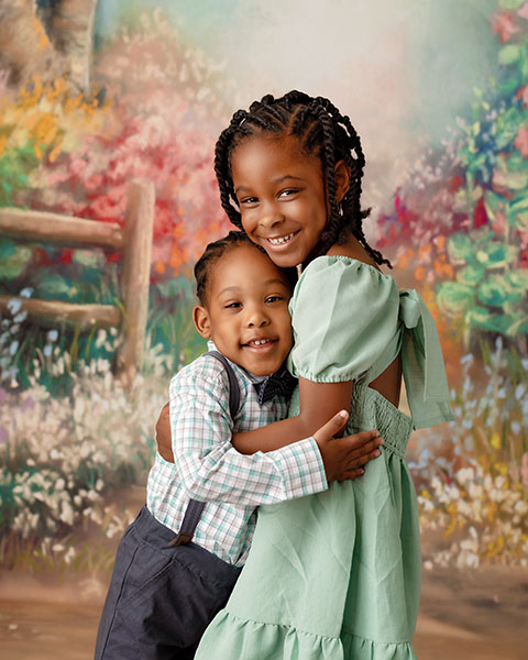 Douglasville children's photographer, siblings hugging during spring studio session