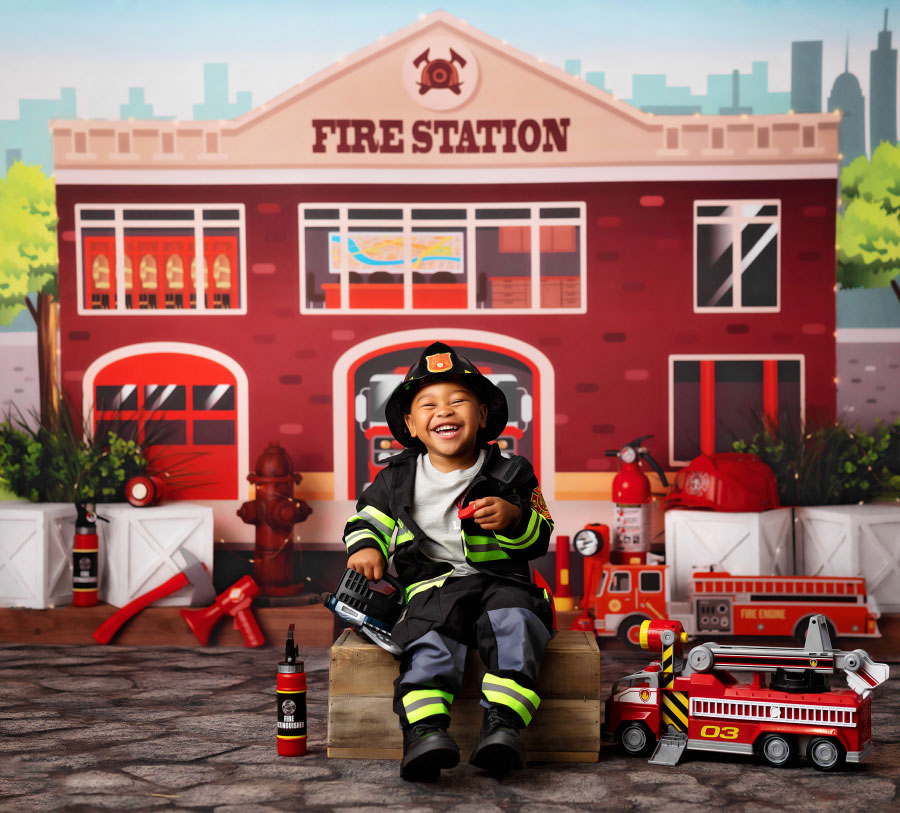 Douglasville kids' photographer, boy laughing on firefighter studio set
