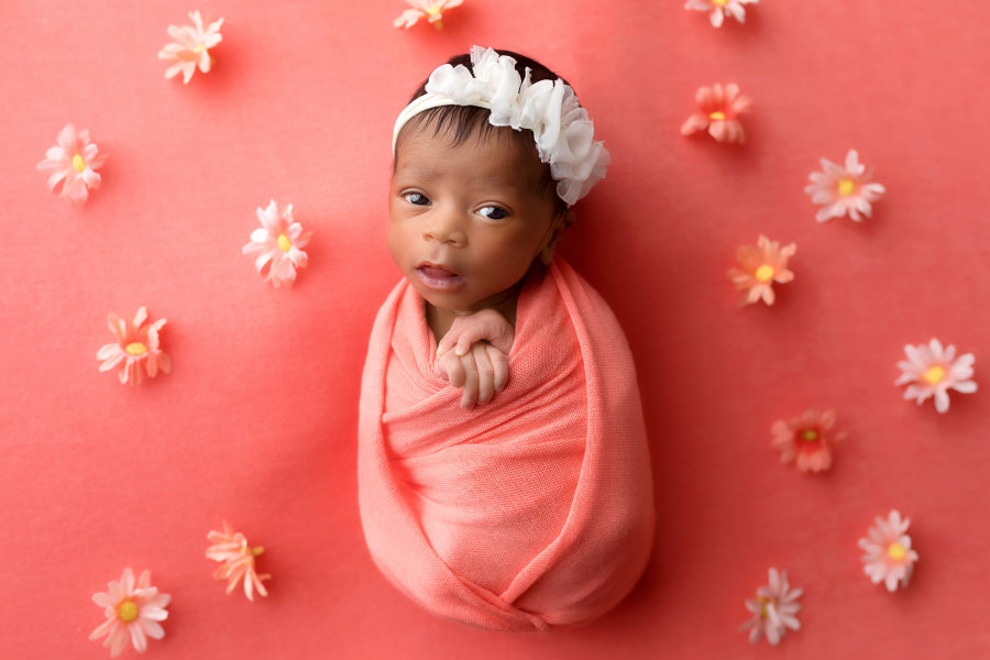 Douglasville newborn photographer, baby girl in coral studio set with flowers