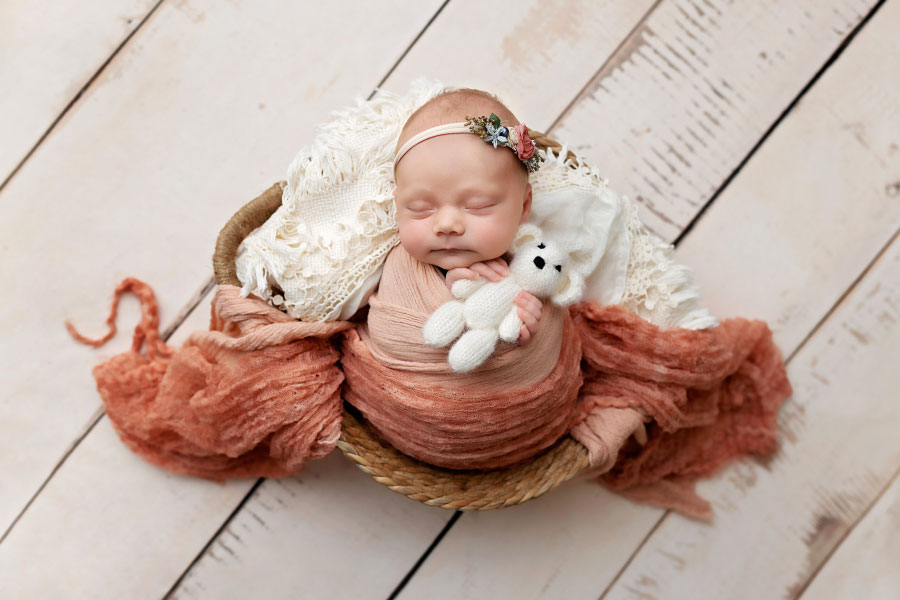 newborn photographer near Powder Springs, baby girl in pink with bear