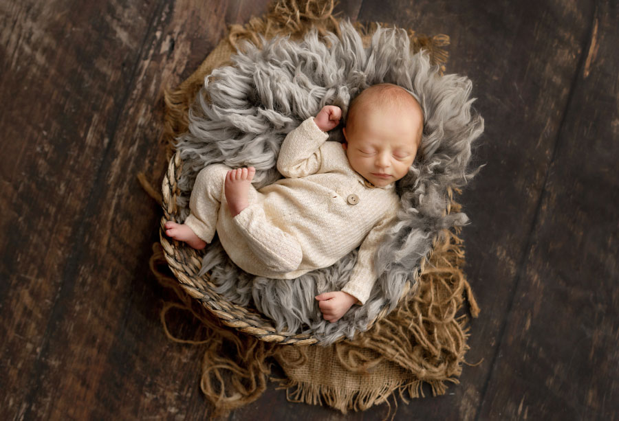 newborn photographer near Villa Rica, baby boy in relaxed pose with pajamas