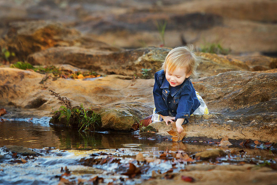 Newnan baby photographer, girl exploring fall leaves